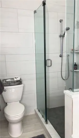 a bathroom with a toilet and a shower