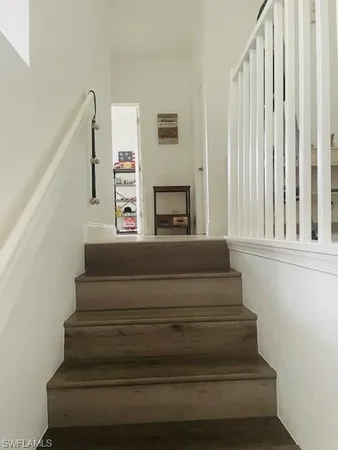 a view of a room with wooden floor and chandelier