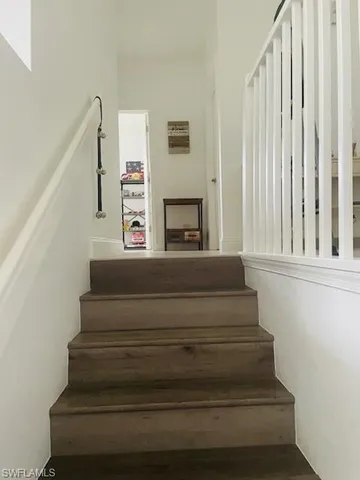 a view of a room with wooden floor and chandelier