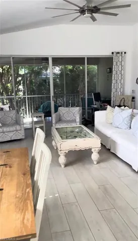 a living room with furniture and a floor to ceiling window