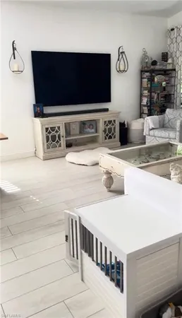 a hallway with a flat screen tv and washer