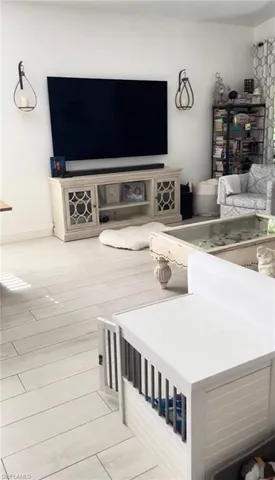 a hallway with a flat screen tv and washer