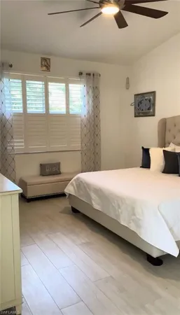 a bedroom with a bed and a night stand