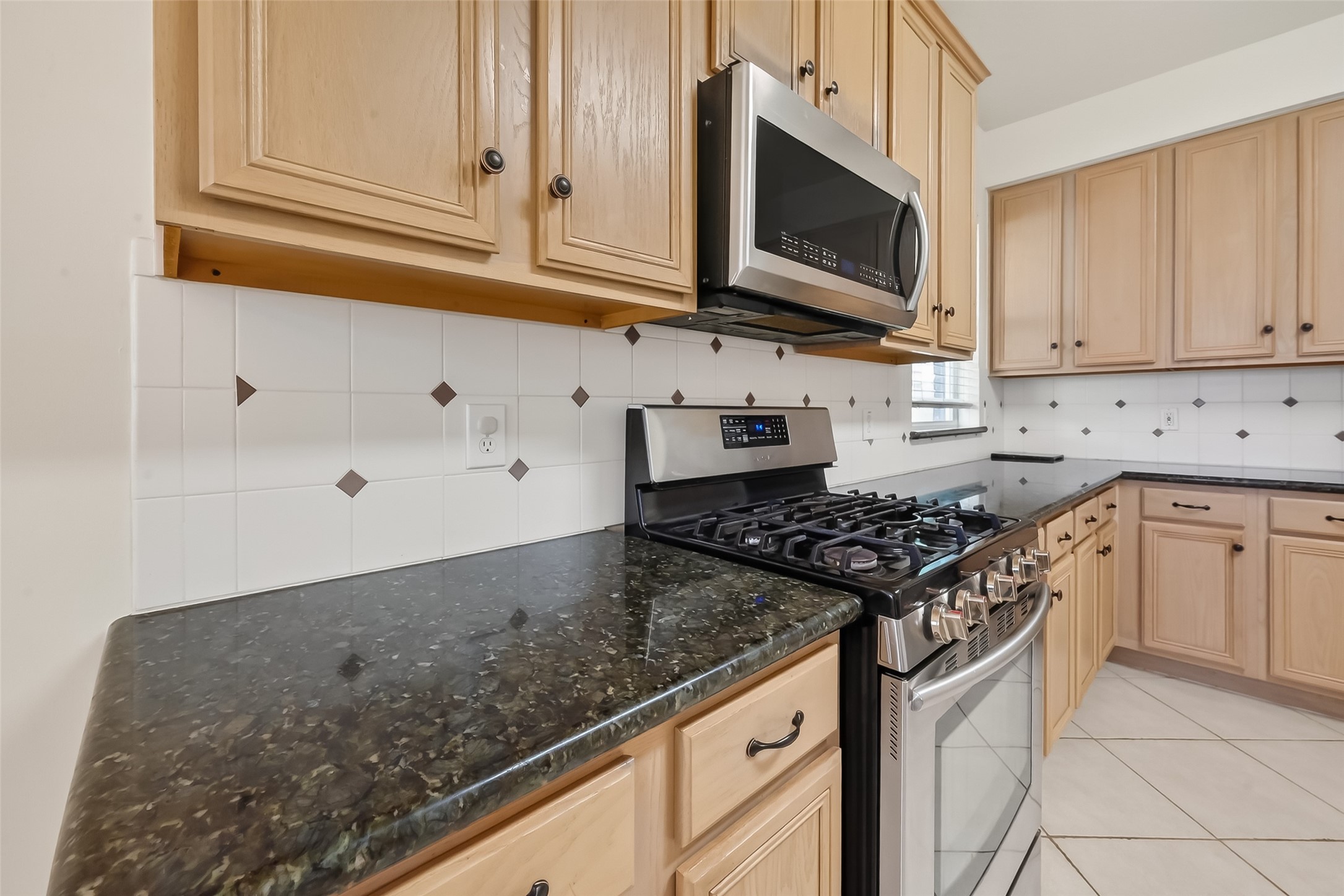 19715 Azalea Brook Way Houston, TX 77084 - Photo 14 of 48 a kitchen with granite countertop white cabinets stainless steel appliances and a sink