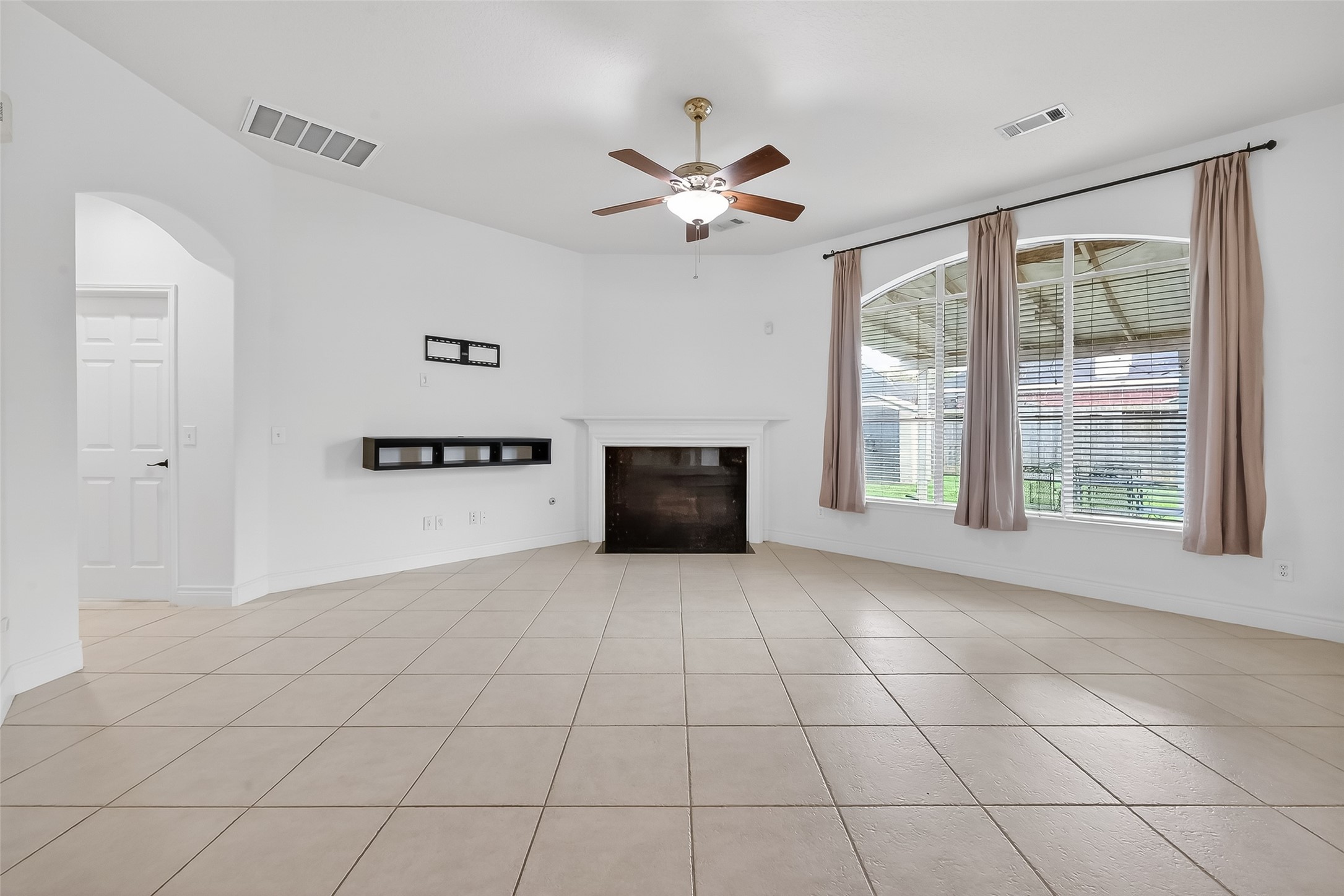 19715 Azalea Brook Way Houston, TX 77084 - Photo 22 of 48 a view of a livingroom with a ceiling fan and window