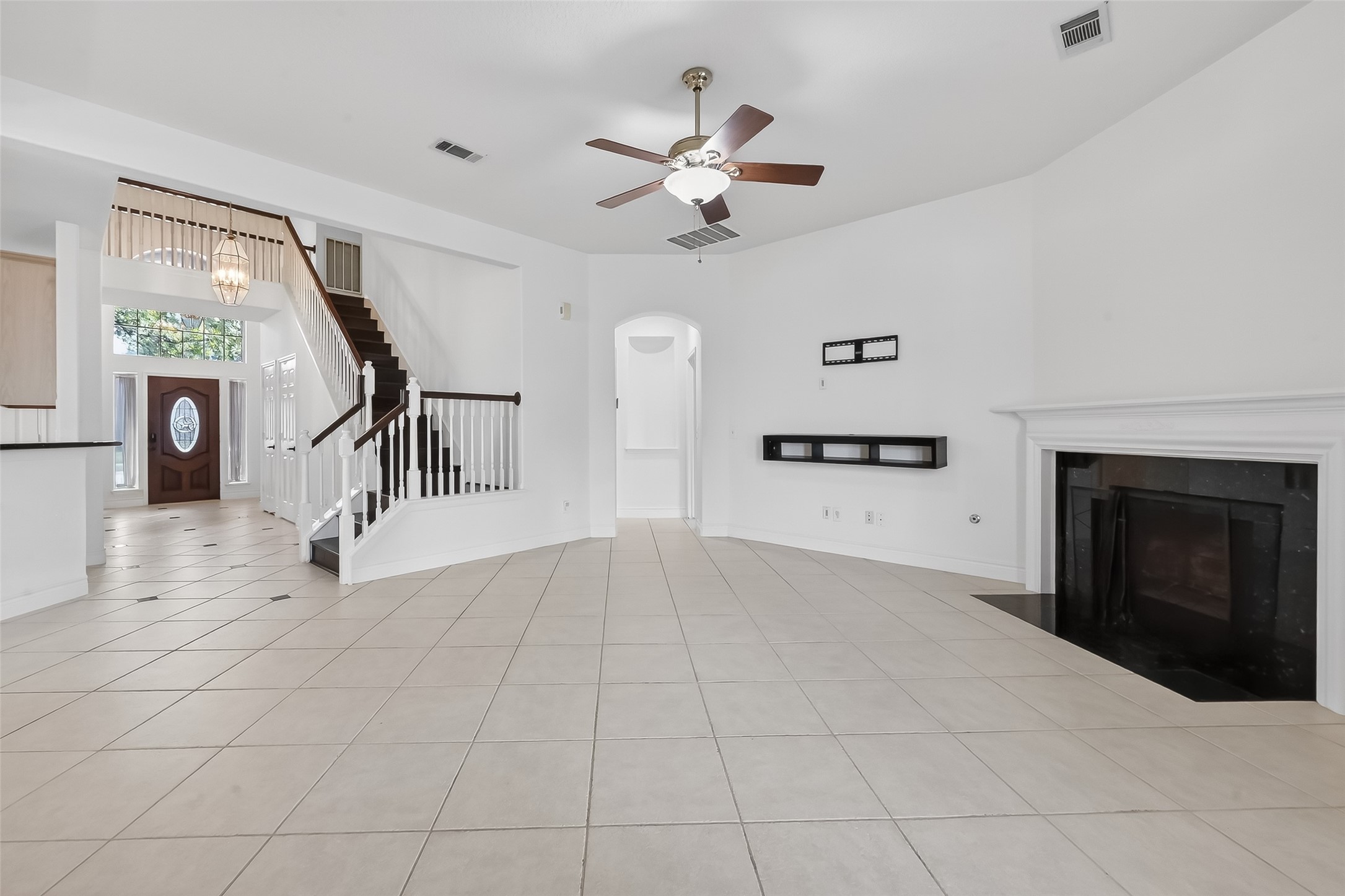 19715 Azalea Brook Way Houston, TX 77084 - Photo 23 of 48 a view of a livingroom with a ceiling fan a fireplace and windows