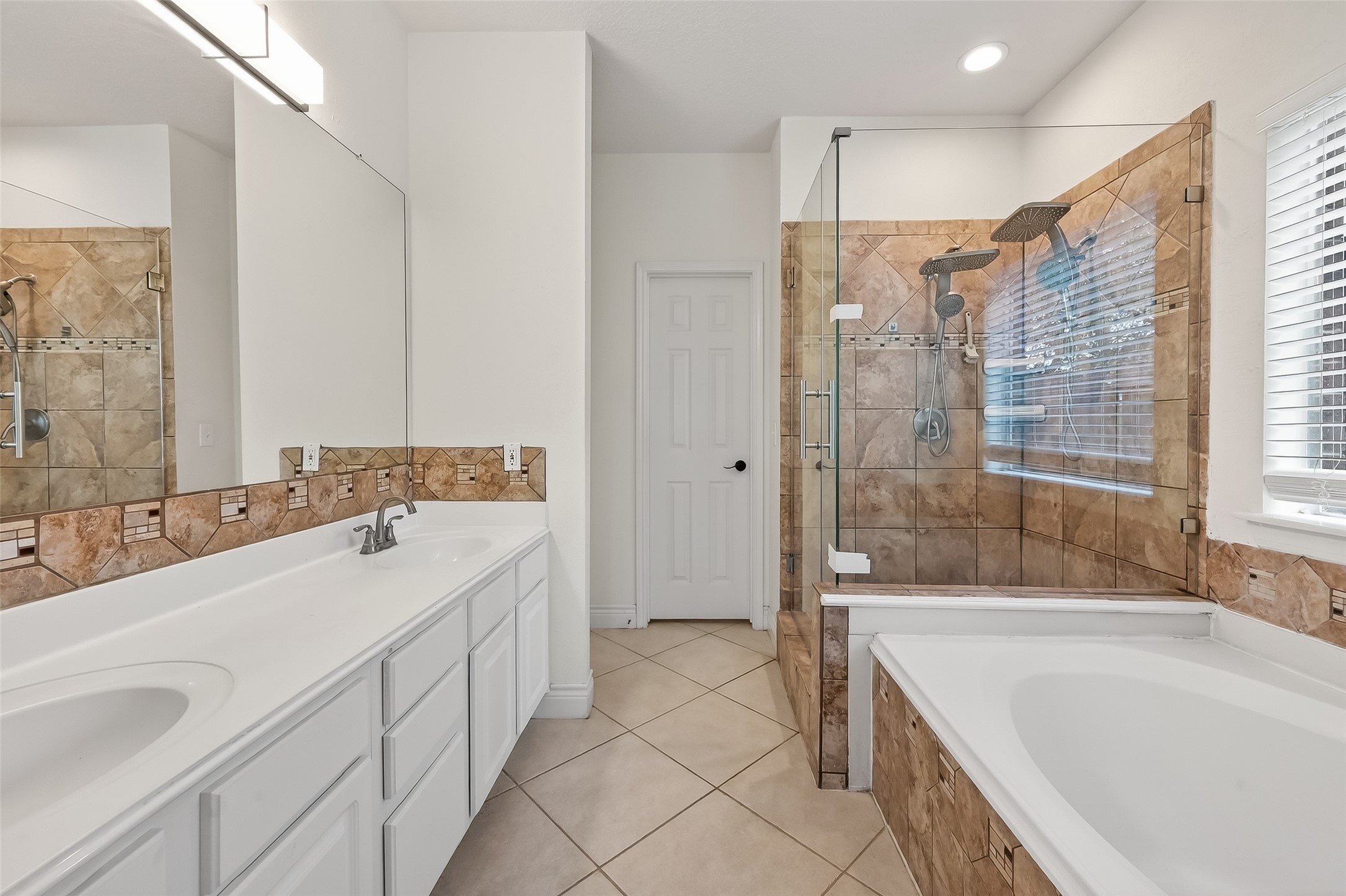 19715 Azalea Brook Way Houston, TX 77084 - Photo 28 of 48 a spacious bathroom with a tub sink and mirror
