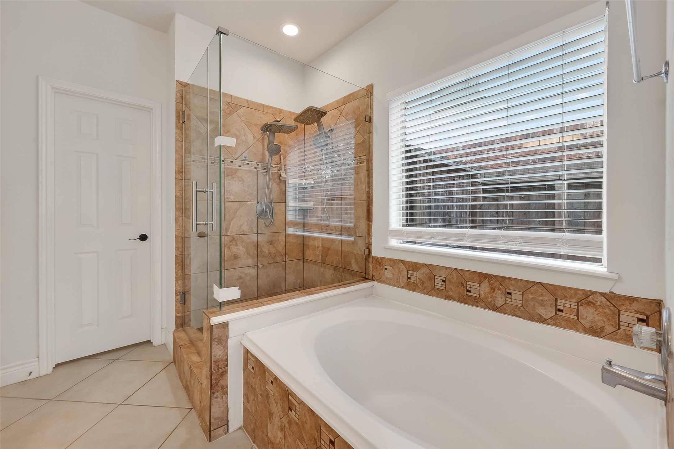 19715 Azalea Brook Way Houston, TX 77084 - Photo 30 of 48 a bathroom with a bathtub and a shower