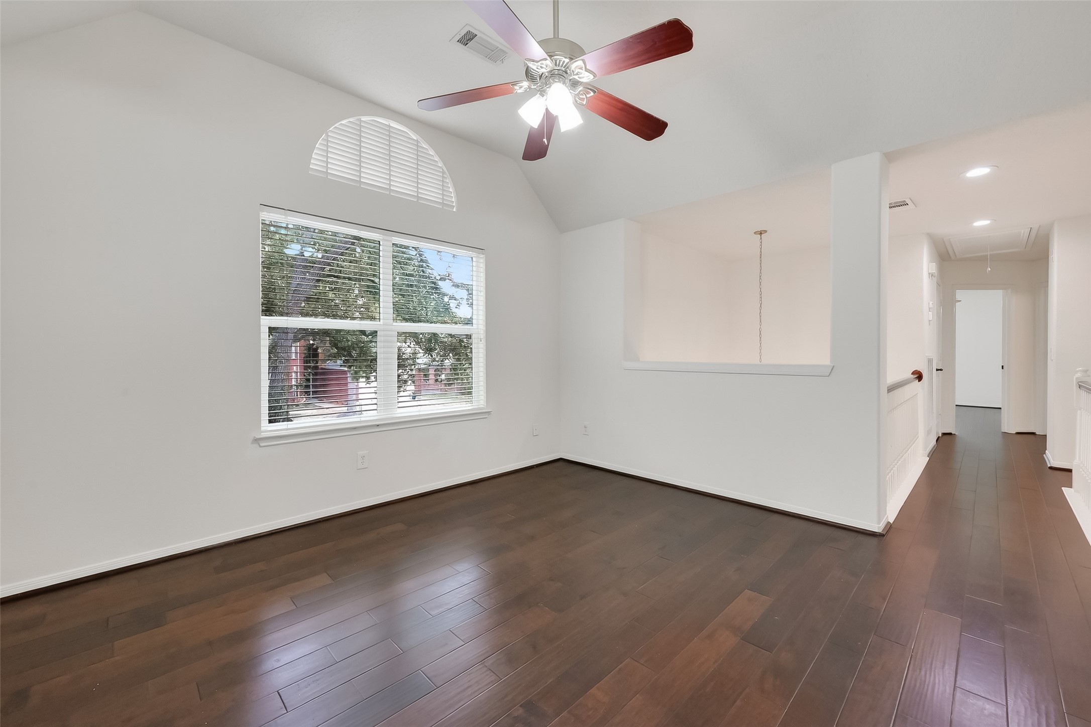 19715 Azalea Brook Way Houston, TX 77084 - Photo 34 of 48 a view of an empty room with wooden floor and a window