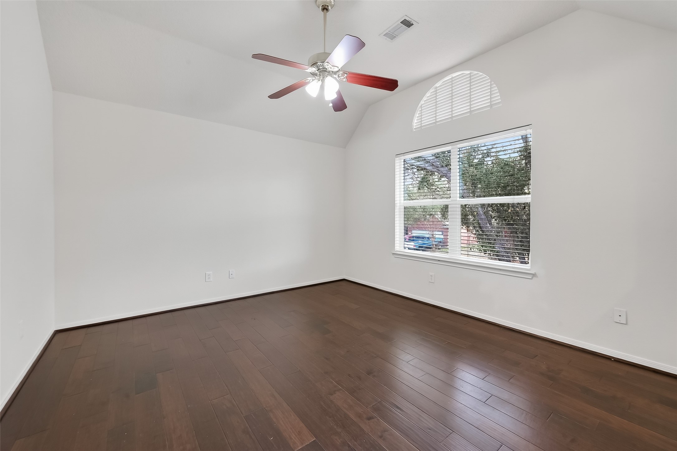 19715 Azalea Brook Way Houston, TX 77084 - Photo 35 of 48 an empty room with wooden floor chandelier fan and windows