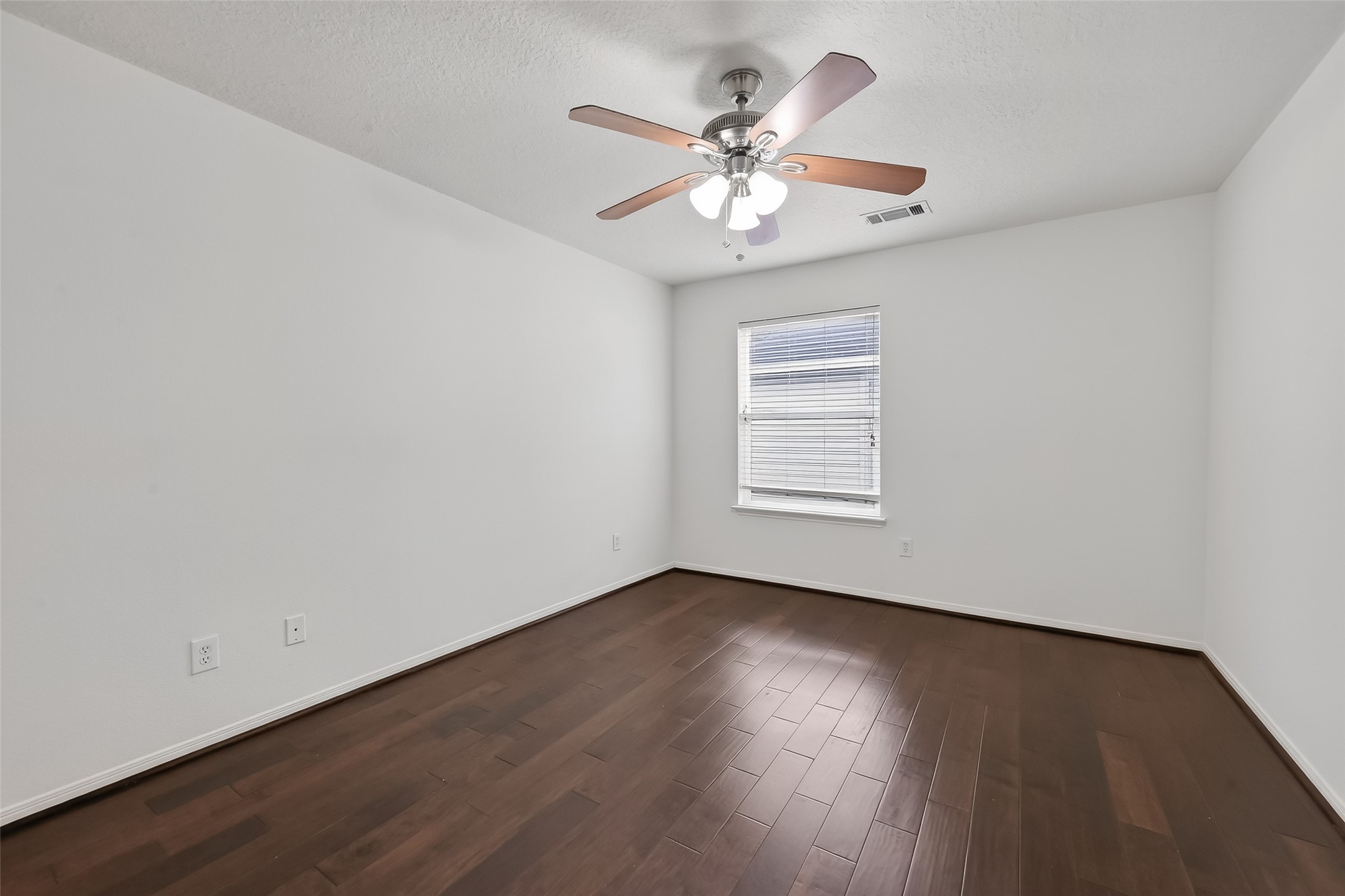 19715 Azalea Brook Way Houston, TX 77084 - Photo 40 of 48 a view of an empty room with wooden floor and a window