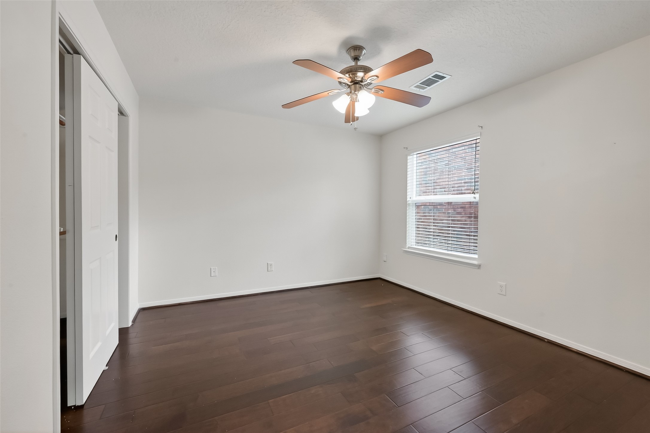 19715 Azalea Brook Way Houston, TX 77084 - Photo 43 of 48 an empty room with wooden floor fan and windows