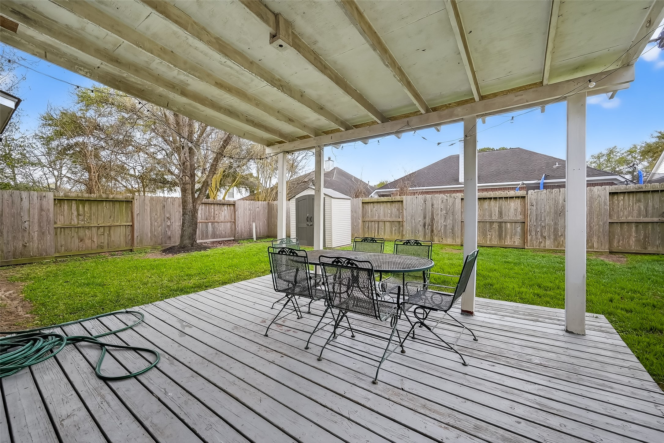 19715 Azalea Brook Way Houston, TX 77084 - Photo 44 of 48 a view of a patio with a table chairs and a backyard