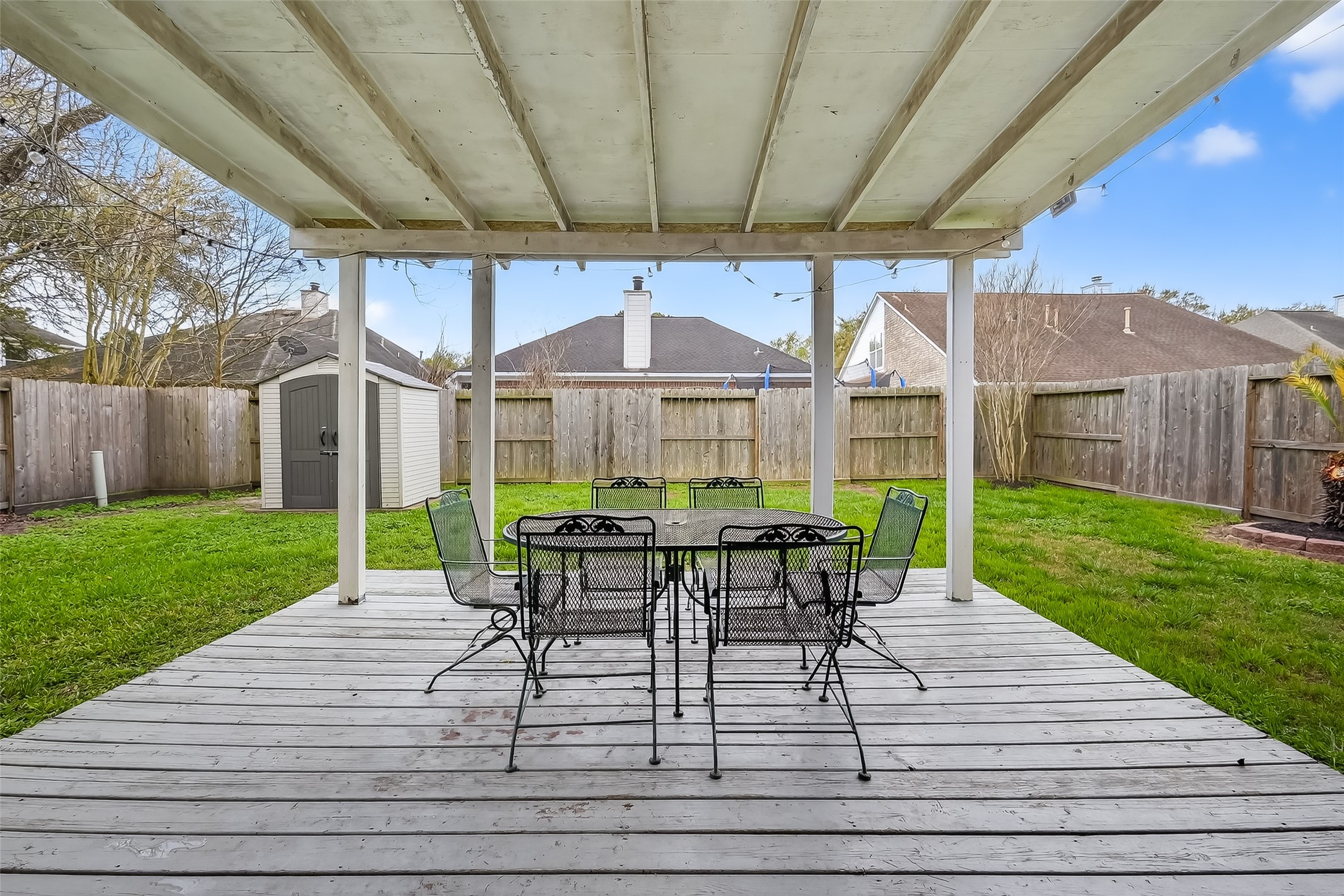 19715 Azalea Brook Way Houston, TX 77084 - Photo 45 of 48 a view of a patio with table and chairs under an umbrella