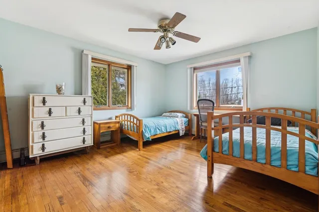a bedroom with a bed couch and a window