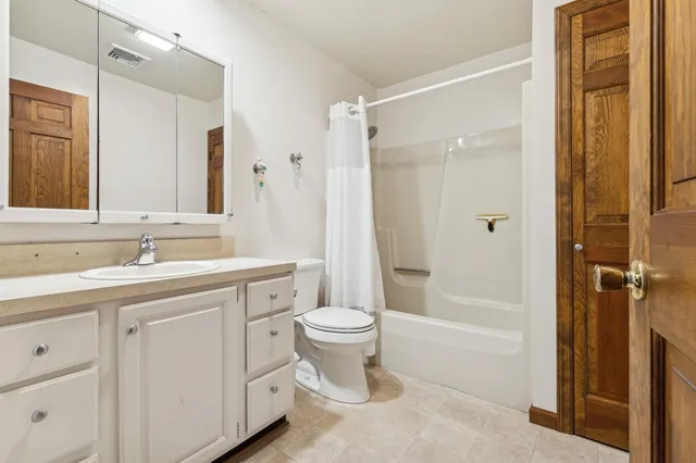 a bathroom with a toilet a sink and a mirror