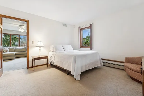 a bedroom with a bed couch and a window