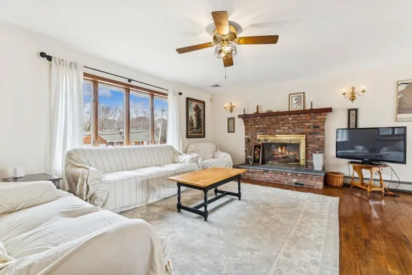 a living room with furniture a fireplace and a flat screen tv