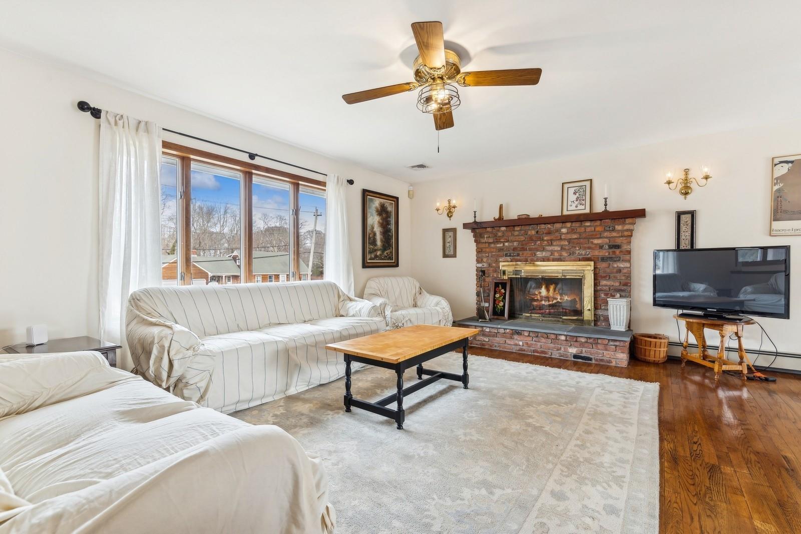 440 Pine Neck Road Southold, NY 11971 - Photo 2 of 21 Large living room with fireplace