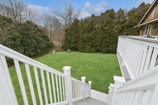 a view of a wooden fence and backyard