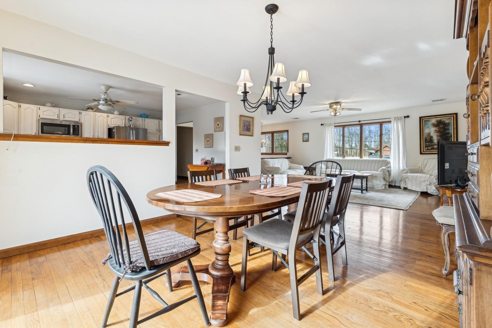 440 Pine Neck Road Southold, NY 11971 - Photo 5 of 21 a view of a dining room with furniture a chandelier and wooden floor
