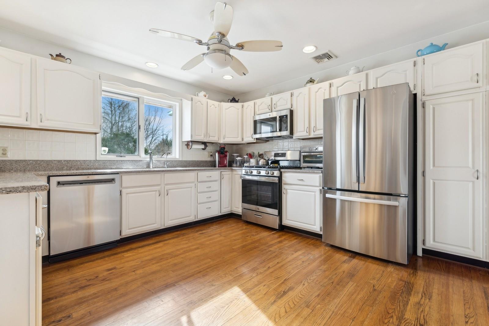 440 Pine Neck Road Southold, NY 11971 - Photo 6 of 21 Kitchen with stainless steel appliances, cultured stone countertops