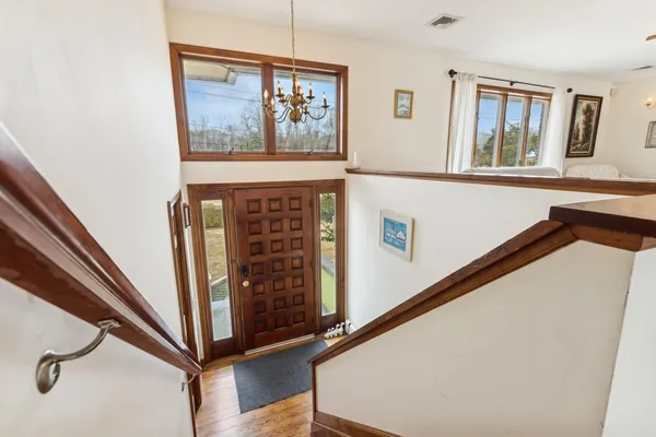 a view of entryway with a window and wooden floor
