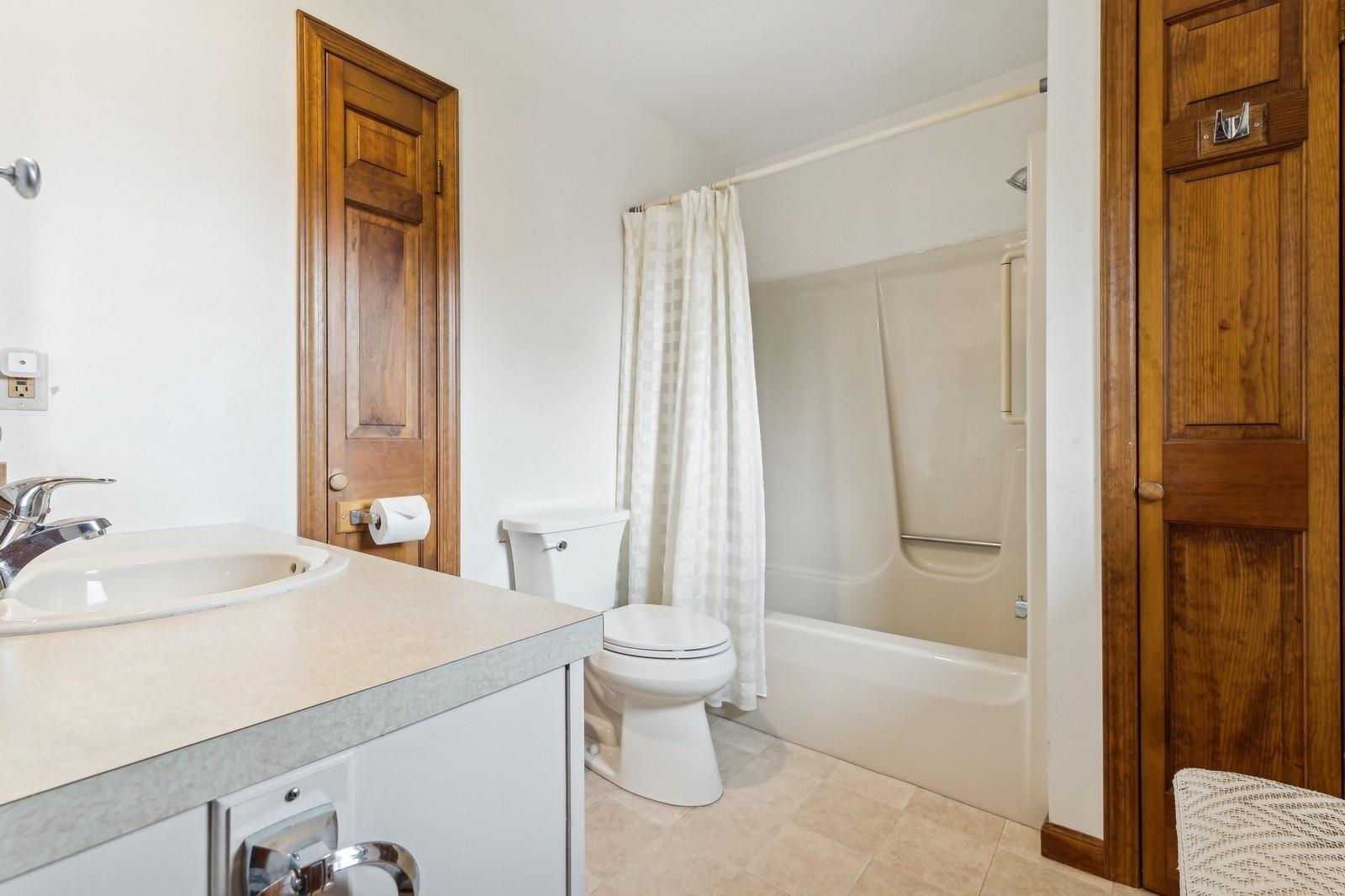 440 Pine Neck Road Southold, NY 11971 - Photo 10 of 21 a bathroom with a sink toilet and shower