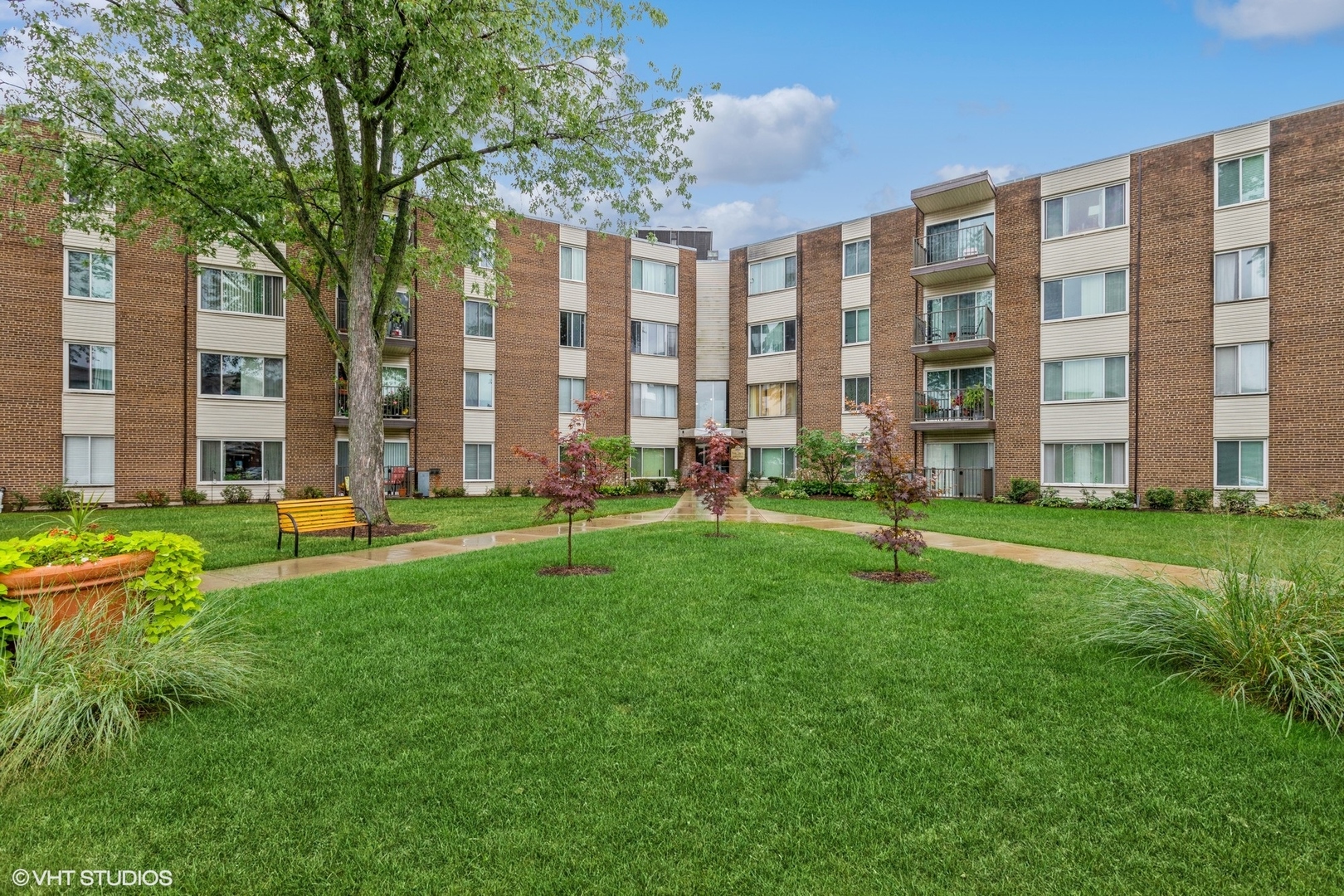 140 West Wood Street, Unit 219 Palatine, IL 60067 - Photo 1 of 10 a garden with trees in front of it