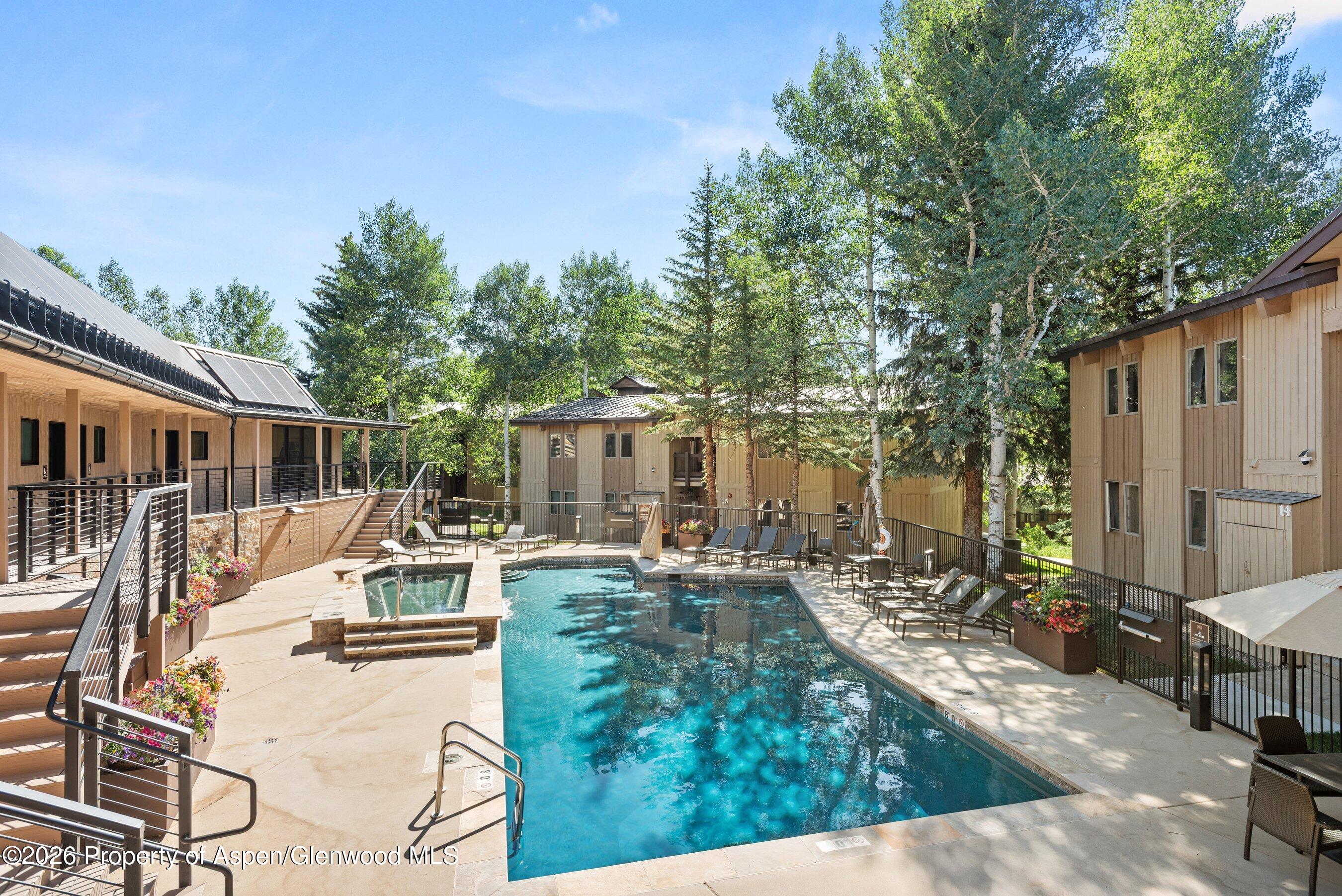 35 Upper Woodbridge Road, Unit 2A Snowmass Village, CO 81615 - Photo 29 of 34 a view of a house with backyard and sitting area