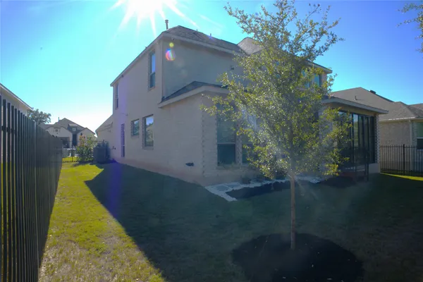 a view of a house with a backyard