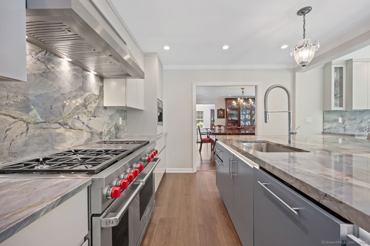 176 Logan Road New Canaan, CT 06840 - Photo 12 of 40 a kitchen with kitchen island stainless steel appliances a sink stove top oven and cabinets