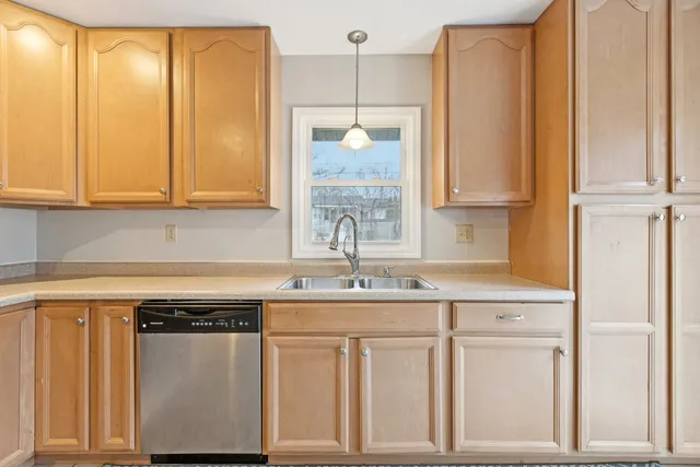 a kitchen with white cabinets and a sink