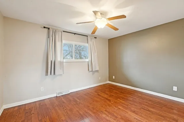 a view of an empty room with a ceiling fan