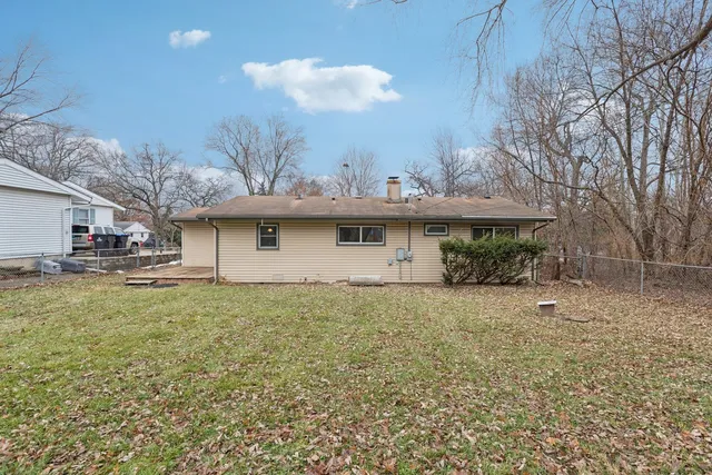 a view of a house with a yard and sitting area