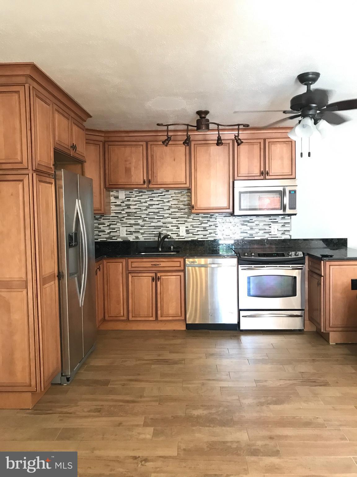 11 1st Street Indian Head, MD 20640 - Photo 5 of 8 a kitchen with stainless steel appliances granite countertop a refrigerator and a stove top oven