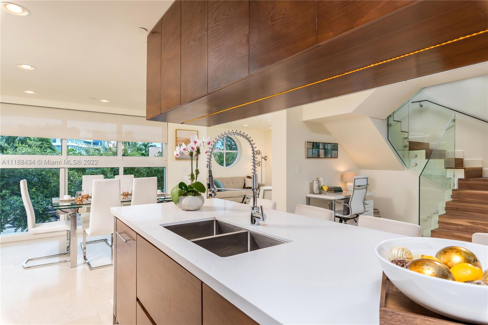 400 Alton Road, Unit TH4A Miami Beach, FL 33139 - Photo 11 of 38 a kitchen with a sink and a stove next to a large window