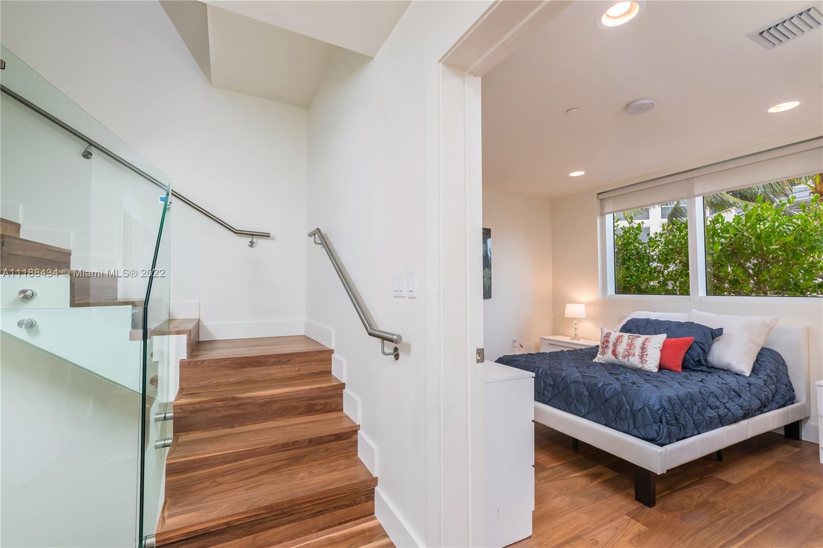 400 Alton Road, Unit TH4A Miami Beach, FL 33139 - Photo 13 of 38 a bedroom with a bed and a large window