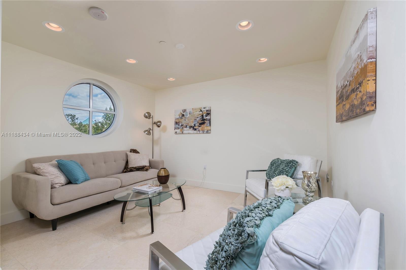 400 Alton Road, Unit TH4A Miami Beach, FL 33139 - Photo 16 of 38 a living room with furniture a couch and a window