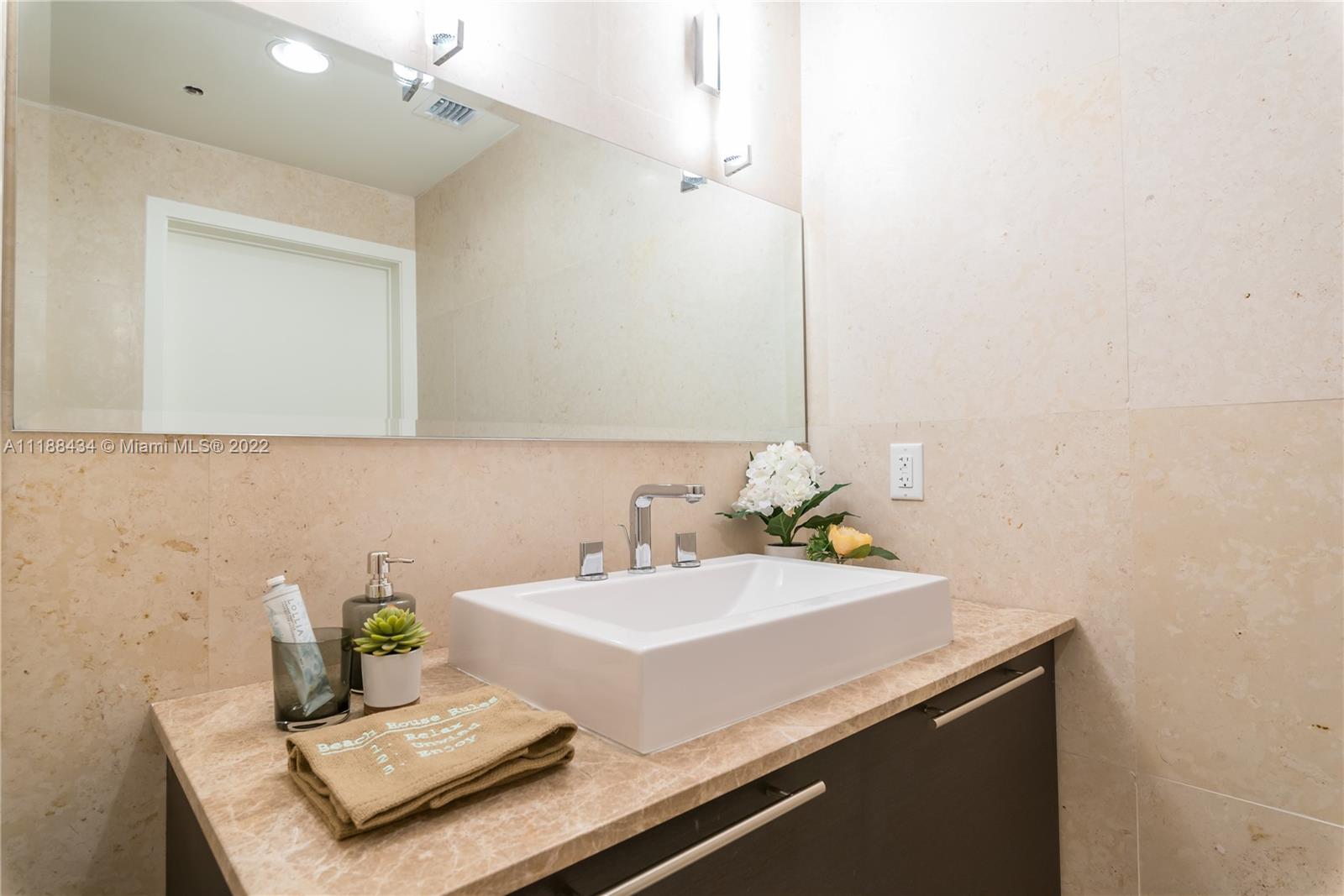400 Alton Road, Unit TH4A Miami Beach, FL 33139 - Photo 18 of 38 a bathroom with a sink and a mirror