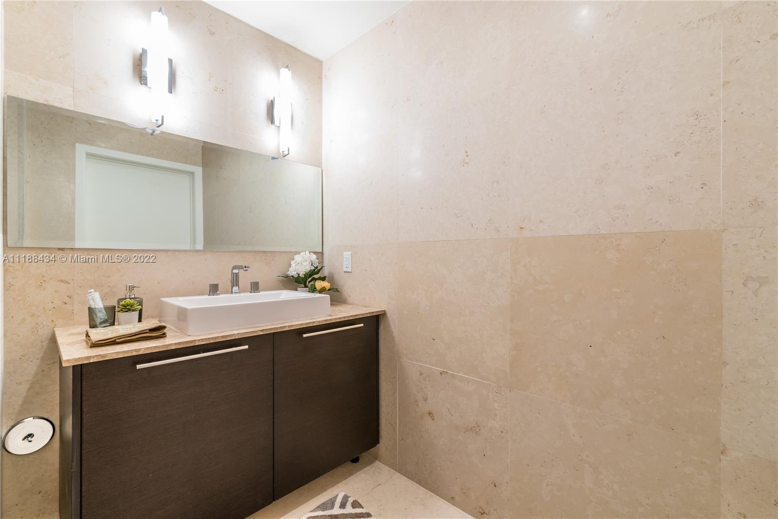 400 Alton Road, Unit TH4A Miami Beach, FL 33139 - Photo 19 of 38 a bathroom with a sink and a mirror