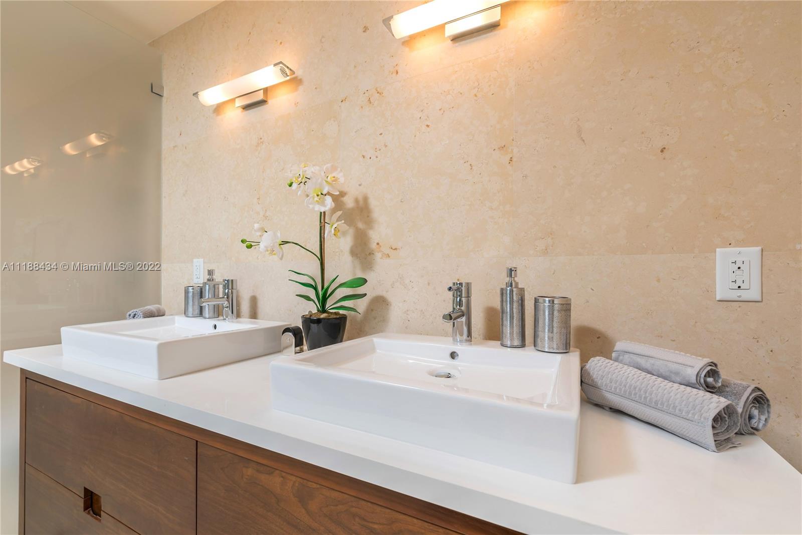 400 Alton Road, Unit TH4A Miami Beach, FL 33139 - Photo 25 of 38 a bathroom with a sink and a mirror