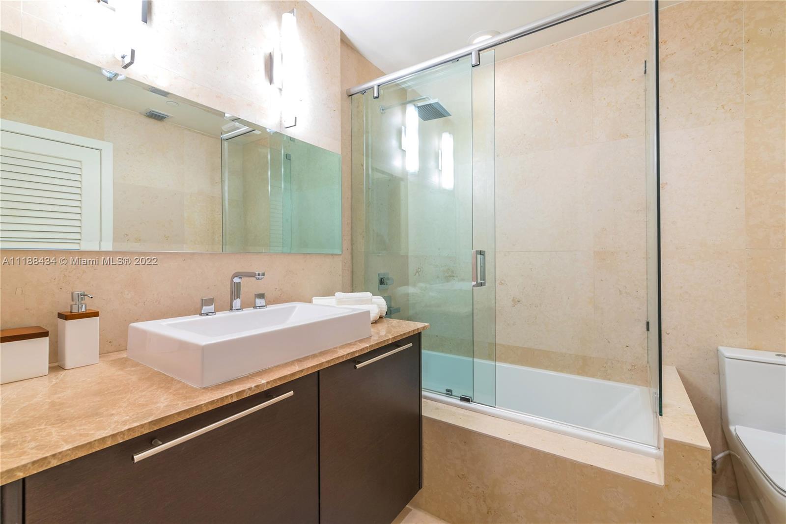 400 Alton Road, Unit TH4A Miami Beach, FL 33139 - Photo 27 of 38 a bathroom with a sink and a mirror