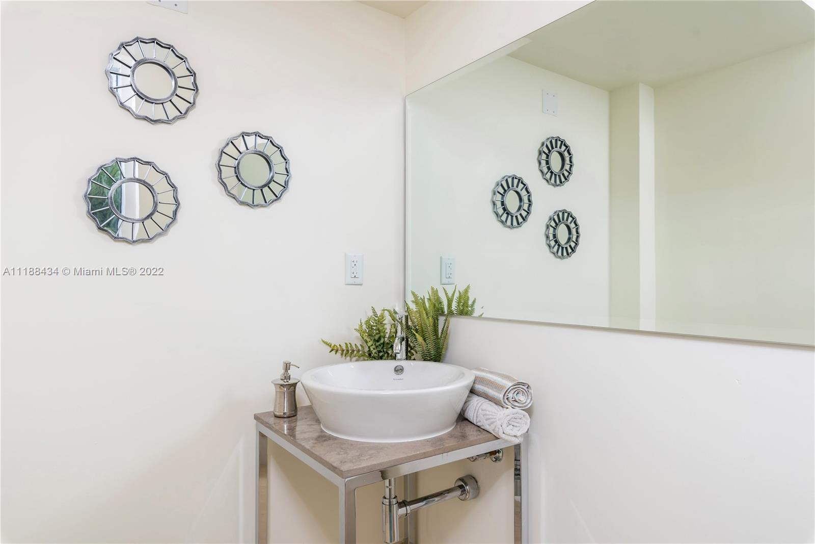 400 Alton Road, Unit TH4A Miami Beach, FL 33139 - Photo 28 of 38 a table with a vase and a plant