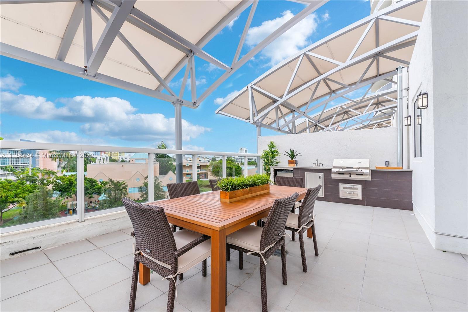 400 Alton Road, Unit TH4A Miami Beach, FL 33139 - Photo 4 of 38 a view of a dinning table and chairs in the patio