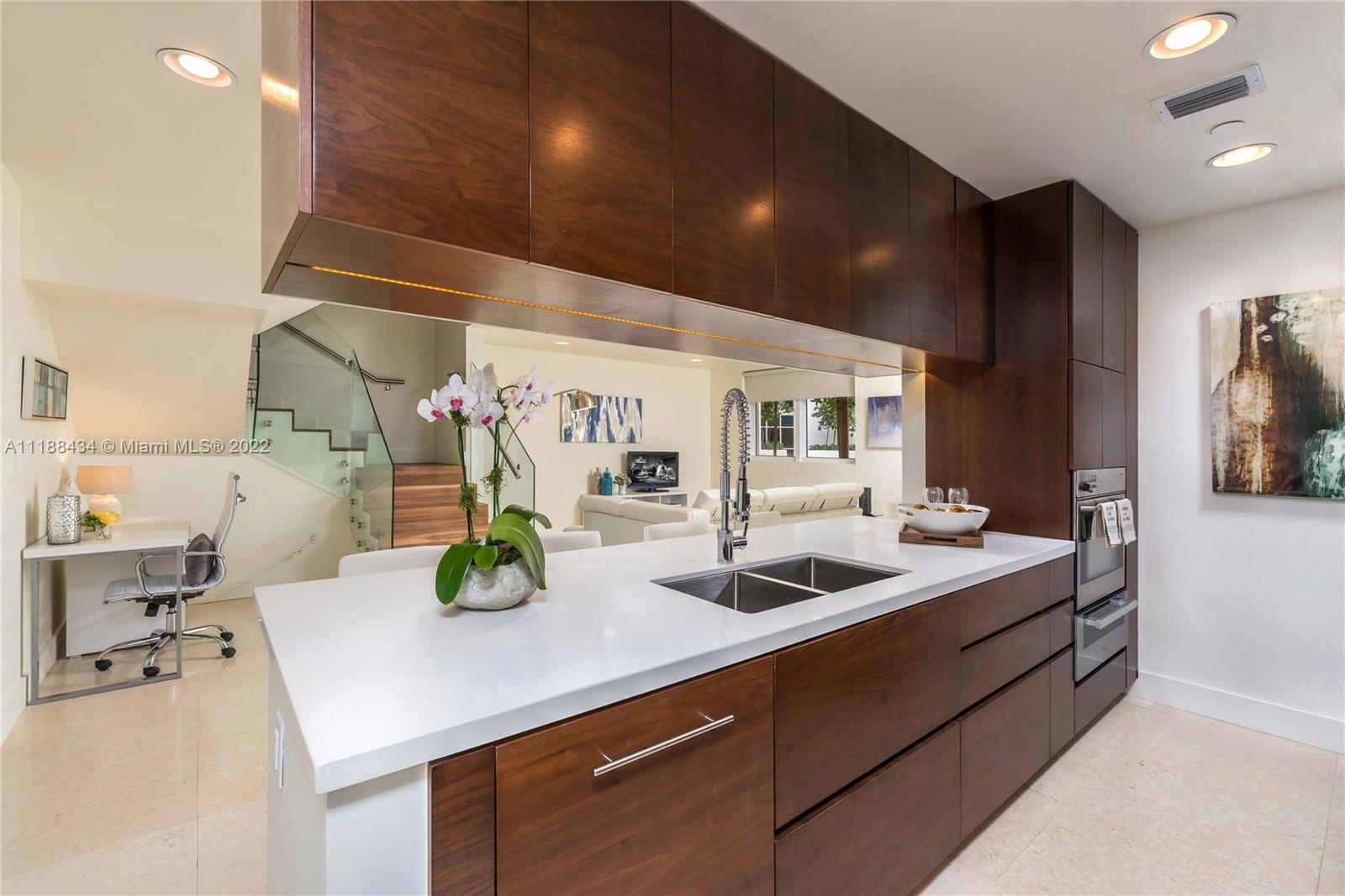 400 Alton Road, Unit TH4A Miami Beach, FL 33139 - Photo 8 of 38 a kitchen with a sink and center island
