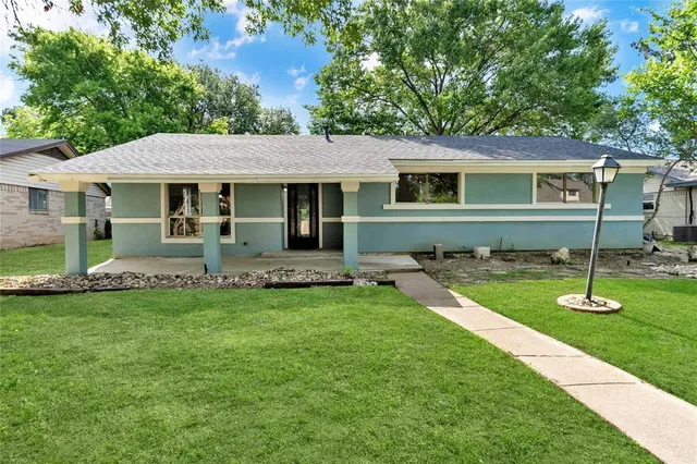 a view of a house with a yard porch and sitting area