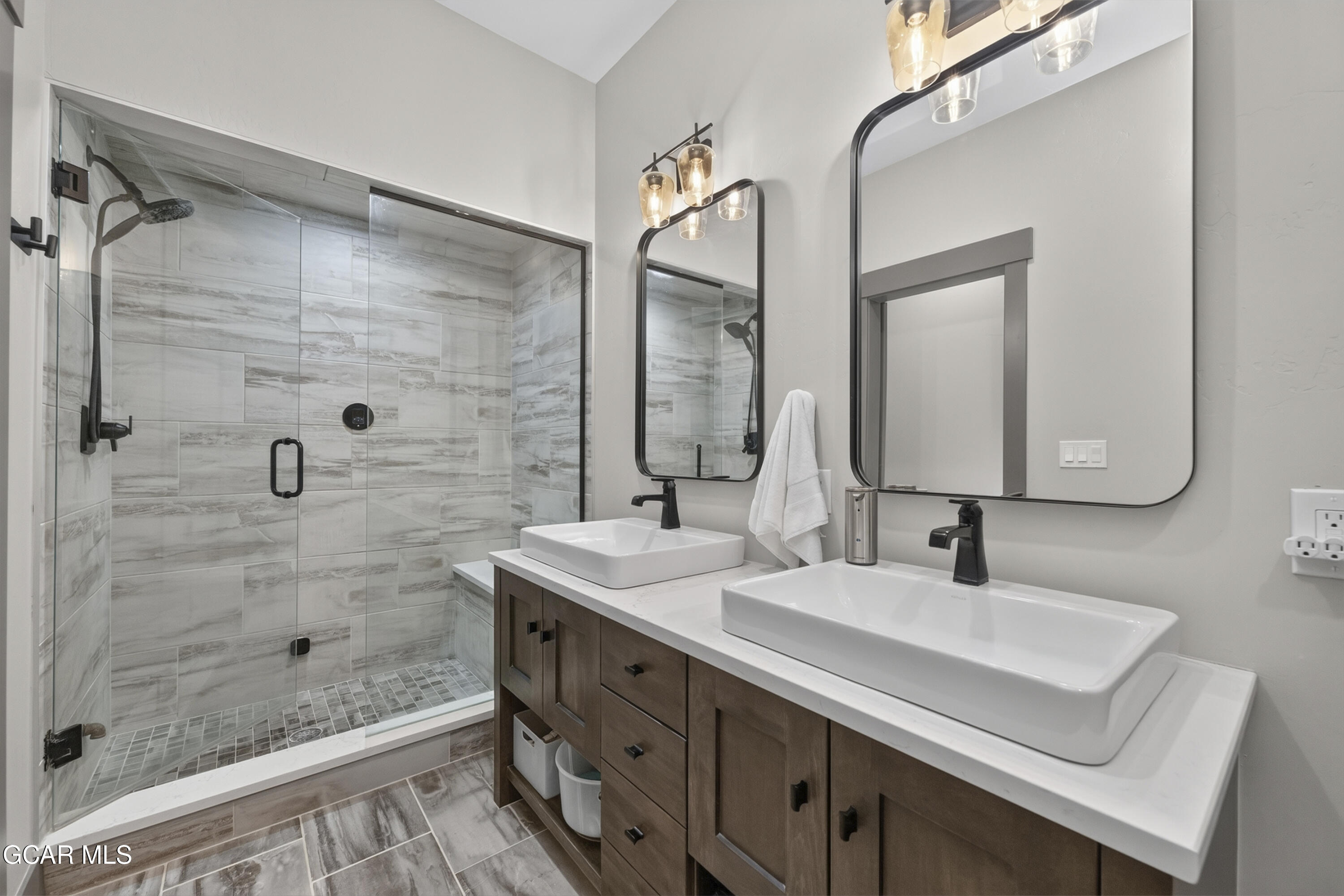 154 Eagle Ridge Drive Granby, CO 80446 - Photo 33 of 59 a bathroom with a sink vanity granite shower and a mirror