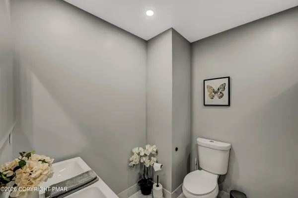 a white toilet sitting next to a bathroom sink