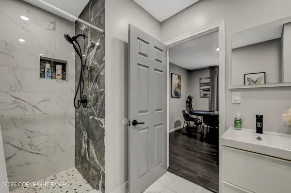 a hallway with a dining table and chairs